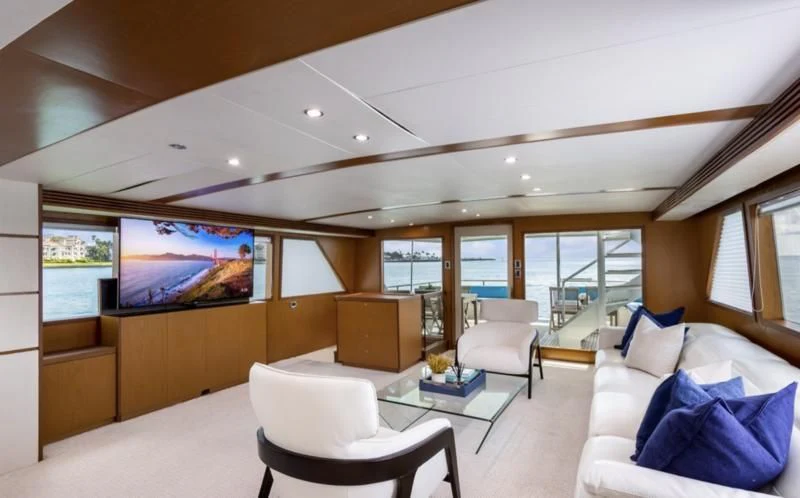 a living room with a large screen aboard DESLIZE Yacht for Sale
