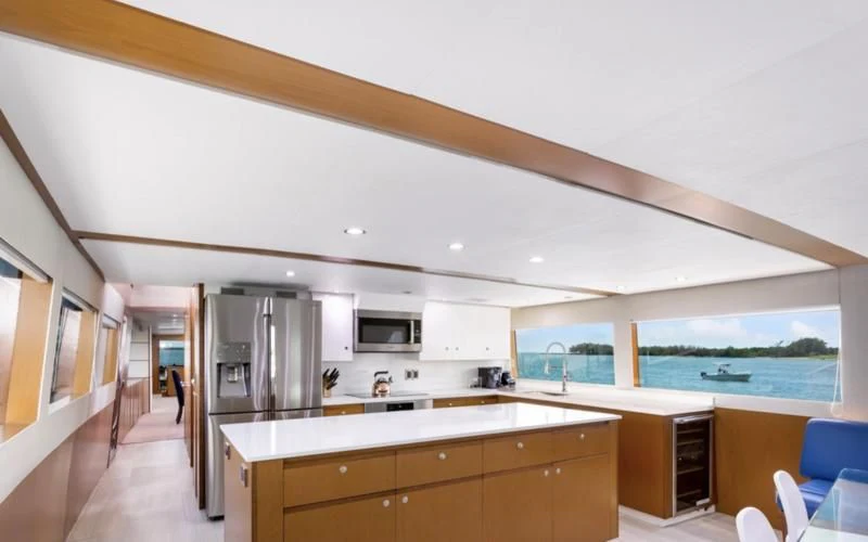 a kitchen with a large window aboard DESLIZE Yacht for Sale