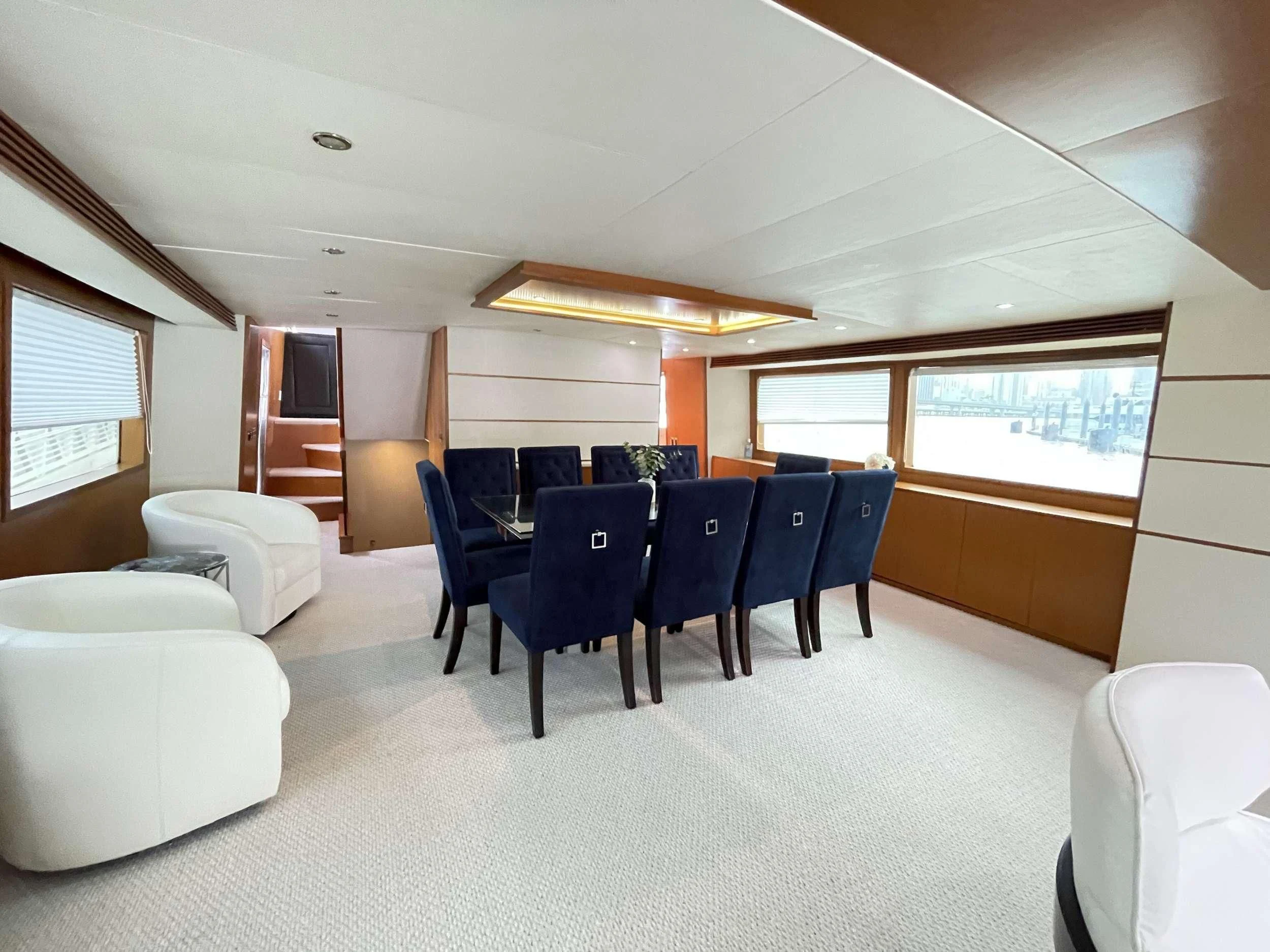 a room with a table and chairs aboard DESLIZE Yacht for Sale