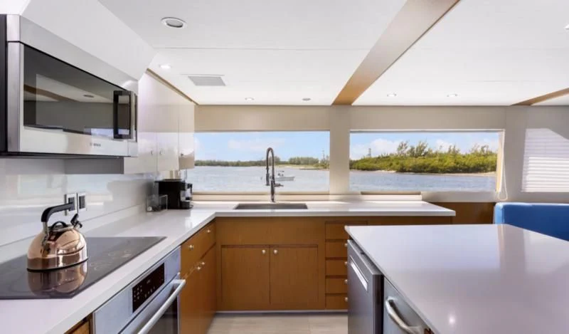 a kitchen with white cabinets aboard DESLIZE Yacht for Sale