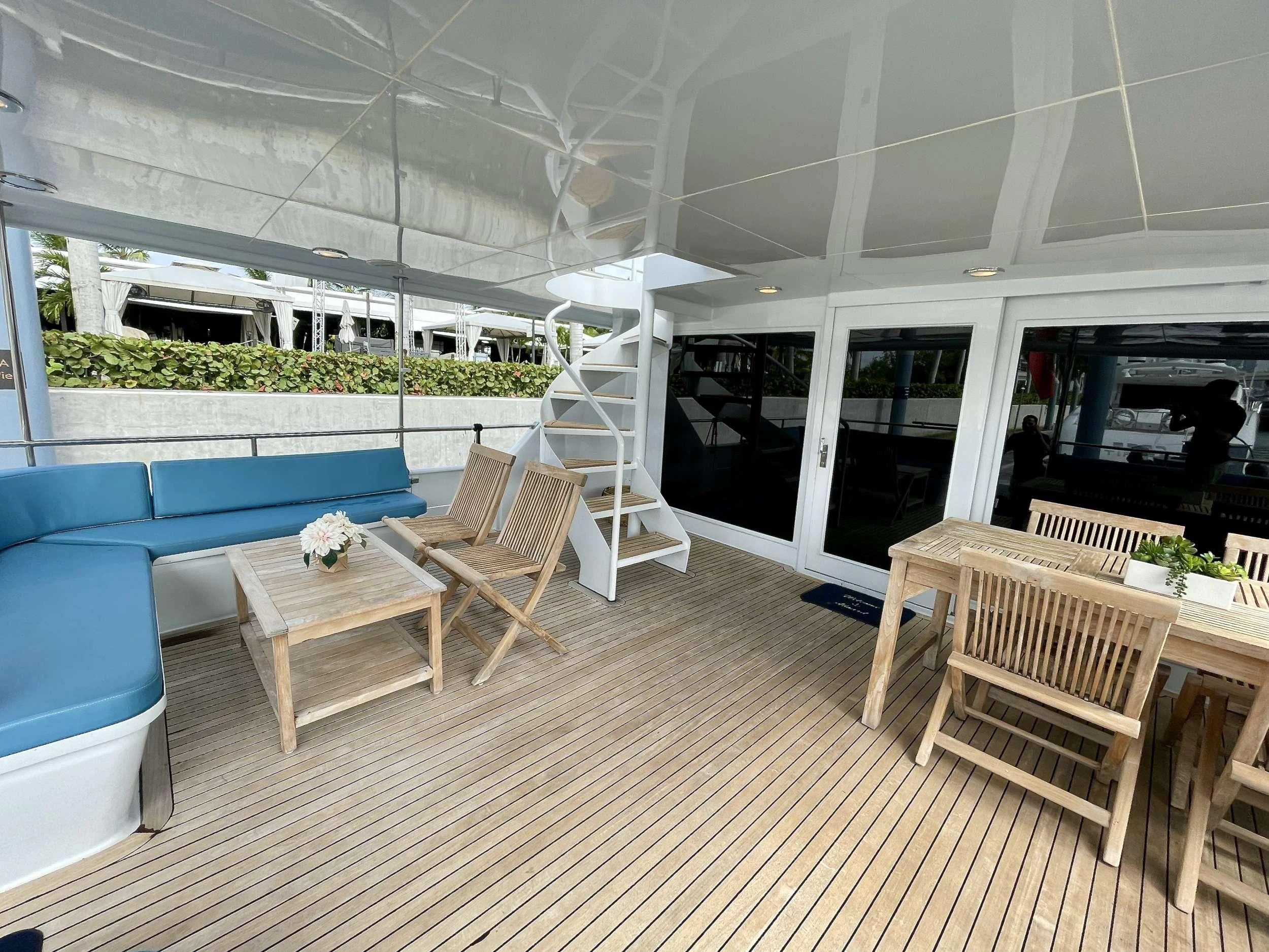 a room with a couch and a table and chairs aboard DESLIZE Yacht for Sale