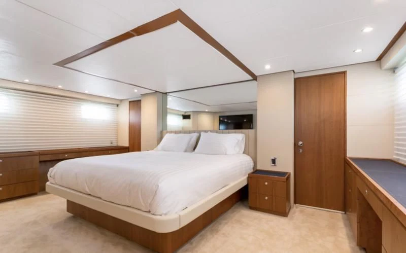 a room with a bed and a wood door aboard DESLIZE Yacht for Sale