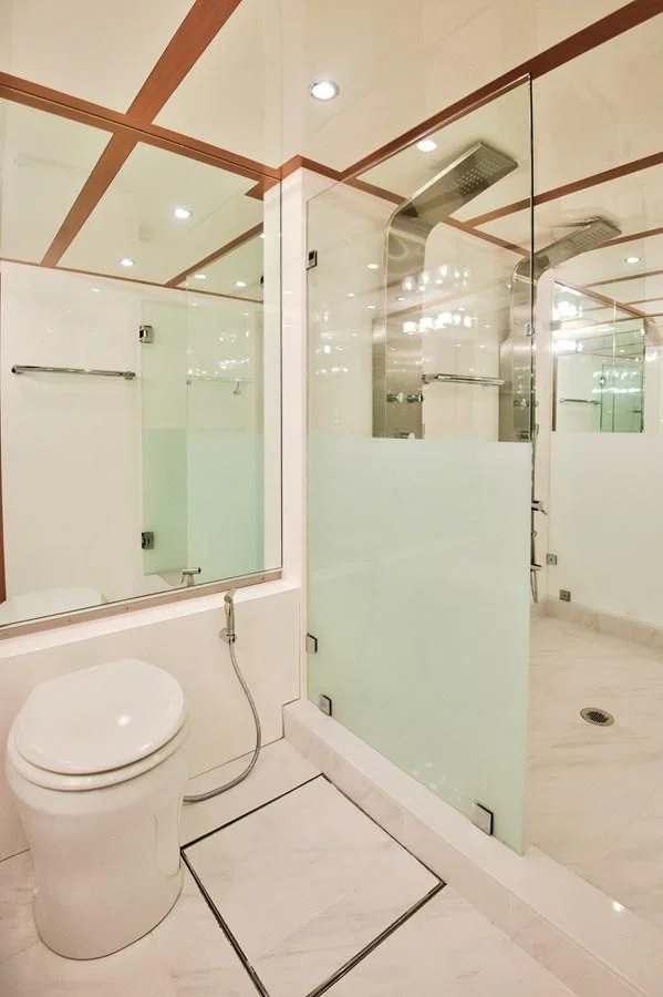 a bathroom with a toilet and a mirror aboard DESLIZE Yacht for Sale