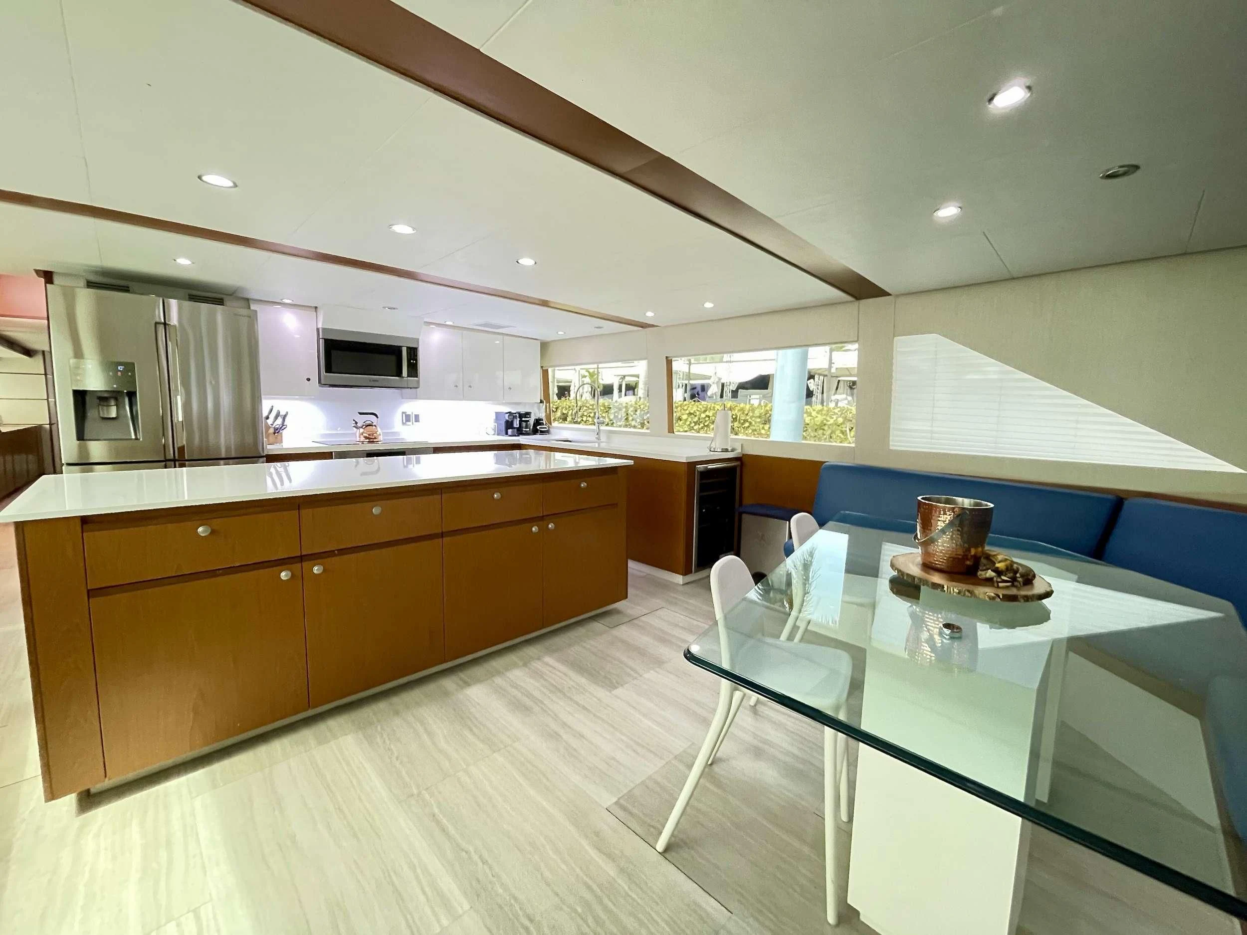 a kitchen with a table and chairs aboard DESLIZE Yacht for Sale