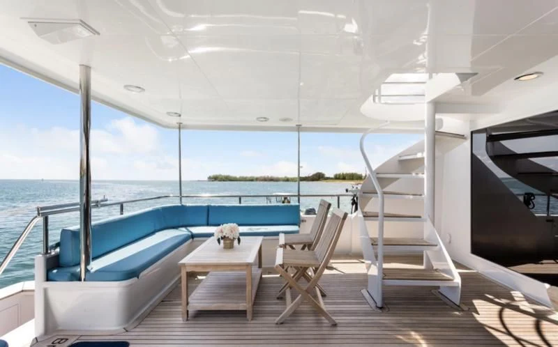 a boat with a table and chairs on a deck aboard DESLIZE Yacht for Sale