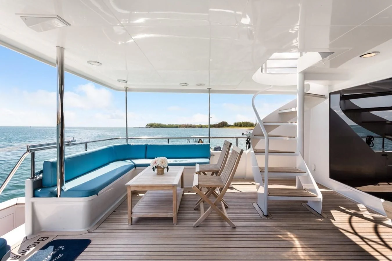 a balcony with a pool and a deck overlooking the water aboard DESLIZE Yacht for Sale