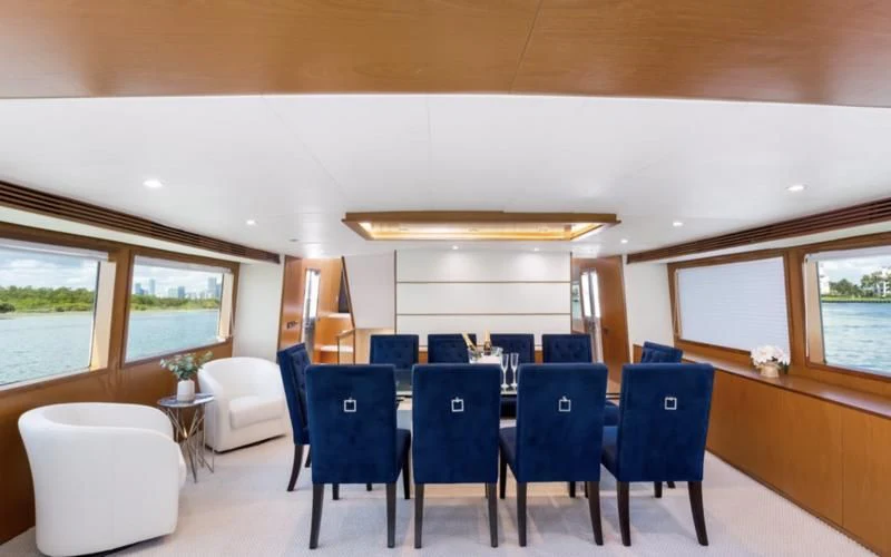 a room with blue chairs and white chairs aboard DESLIZE Yacht for Sale