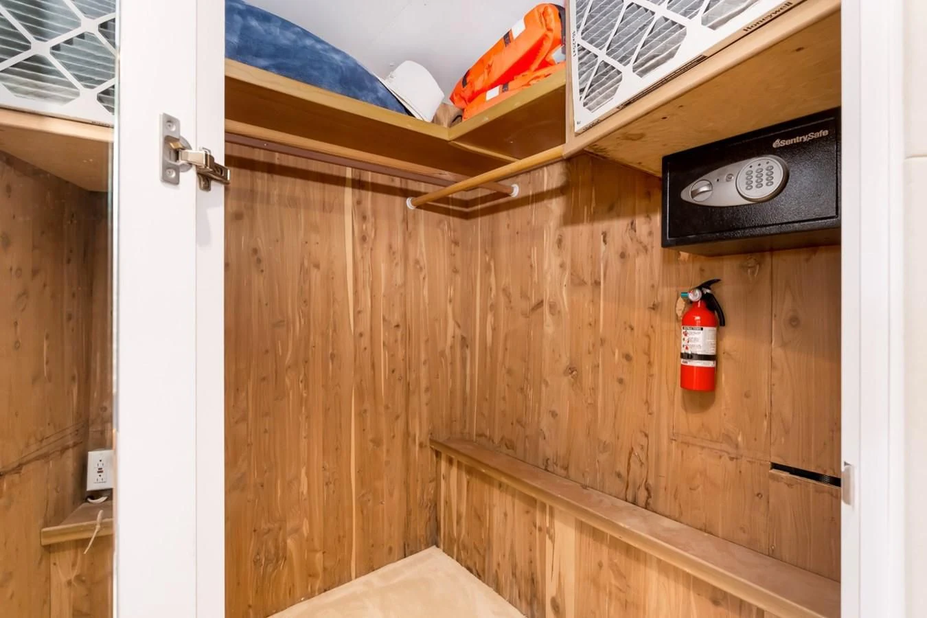 a wood cabinet with a red beverage can and a vent on it aboard DESLIZE Yacht for Sale