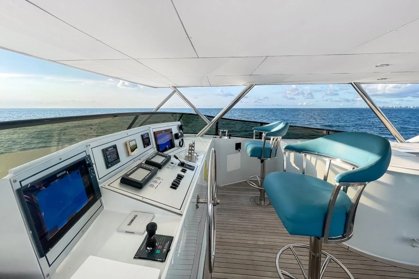 a boat with a screen and a couple of chairs on it aboard DESLIZE Yacht for Sale