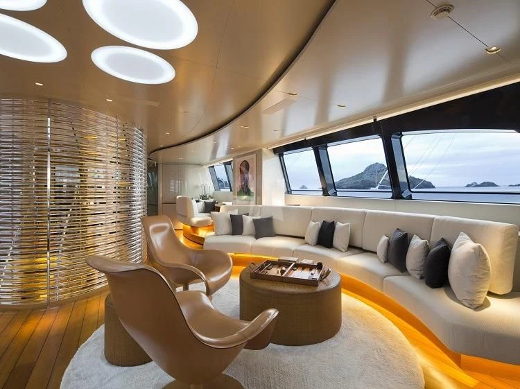 a room with a couch and a table aboard PANTHALASSA Yacht for Sale