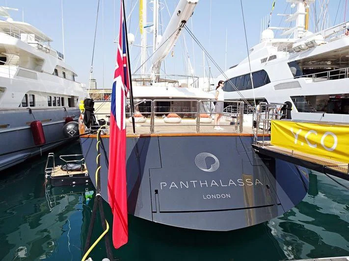 a boat with a flag on it aboard PANTHALASSA Yacht for Sale