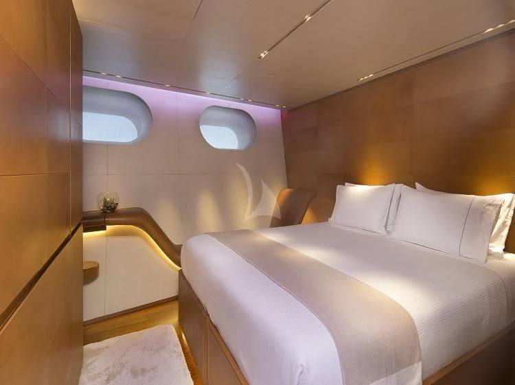 a room with a bed and a window aboard PANTHALASSA Yacht for Sale