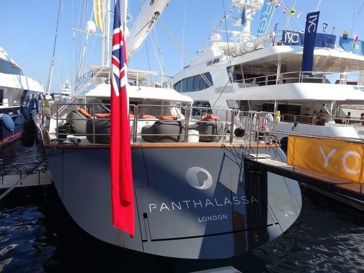 a boat with a red stripe aboard PANTHALASSA Yacht for Sale