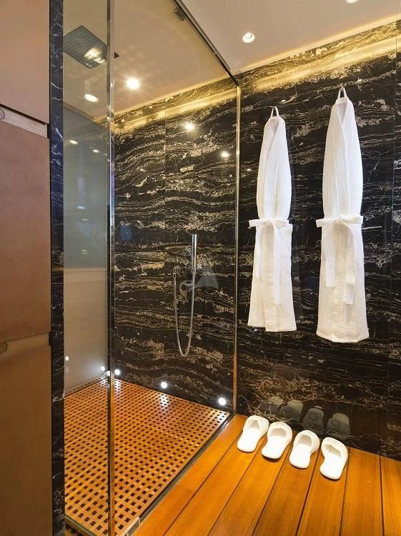 a bathroom with a large mirror aboard PANTHALASSA Yacht for Sale