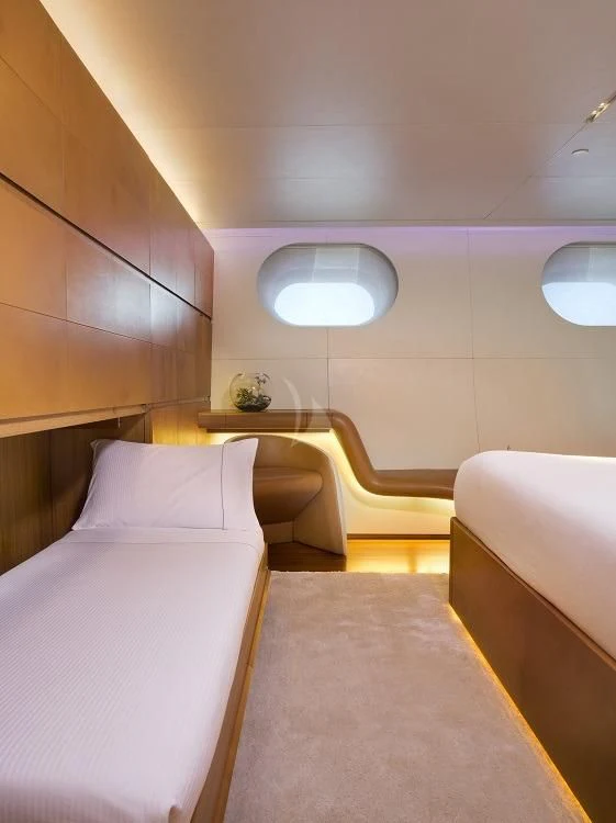 a room with a bed and a round mirror aboard PANTHALASSA Yacht for Sale