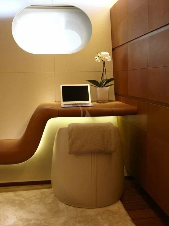 a white chair with a laptop on it aboard PANTHALASSA Yacht for Sale