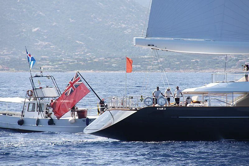 a boat with a flag on it aboard PANTHALASSA Yacht for Sale