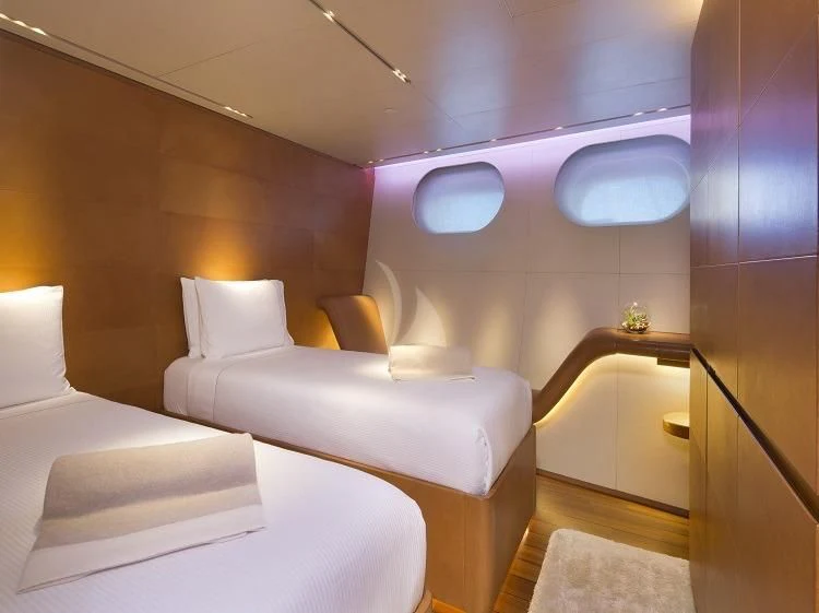 a room with white couches aboard PANTHALASSA Yacht for Sale