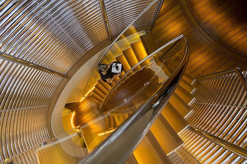 a person sitting in a large glass ceiling aboard PANTHALASSA Yacht for Sale