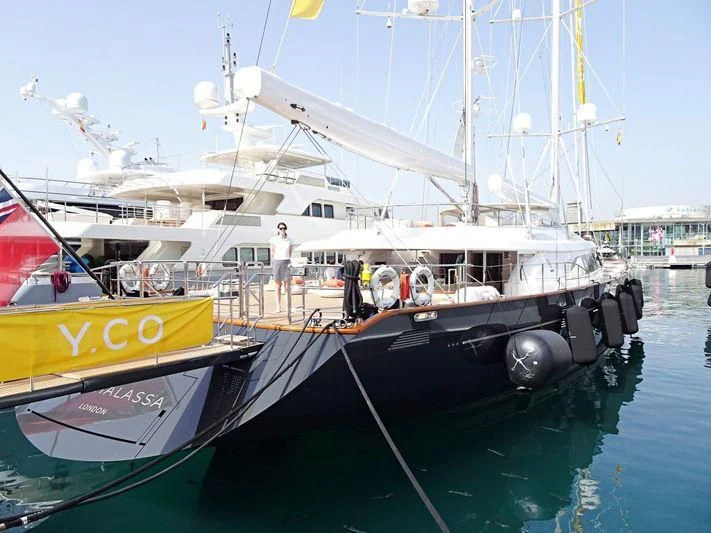 a boat with a person standing on the deck aboard PANTHALASSA Yacht for Sale