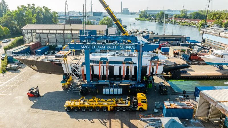 a crane lifting a container aboard PANTHALASSA Yacht for Sale