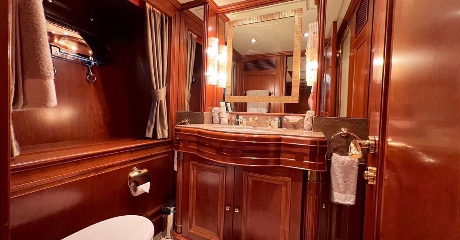 a bathroom with a large mirror aboard BENETTI TRADITION 100 Yacht for Sale