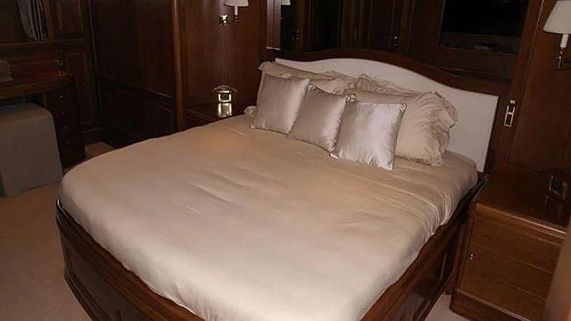 a bed with white sheets aboard BENETTI TRADITION 100 Yacht for Sale