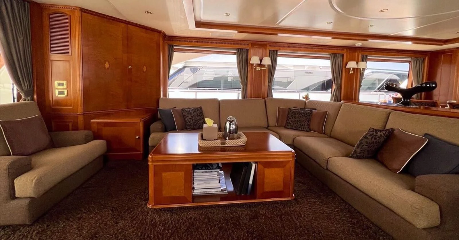 a living room with a couch and a coffee table aboard BENETTI TRADITION 100 Yacht for Sale