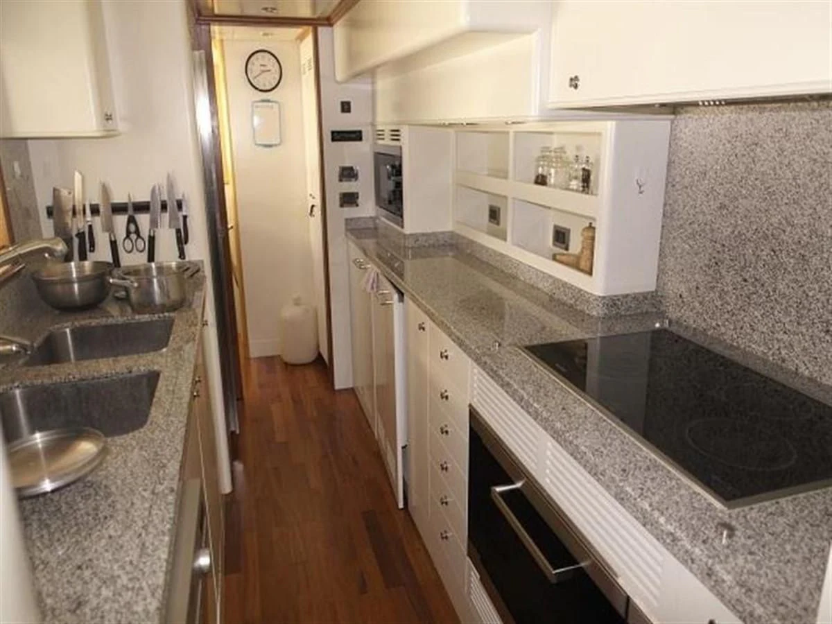 a kitchen with a sink and a refrigerator aboard BENETTI TRADITION 100 Yacht for Sale
