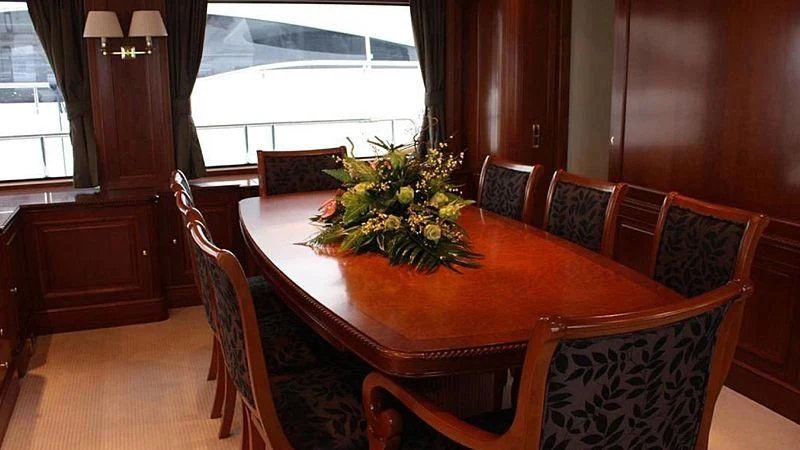 a dining table with flowers aboard BENETTI TRADITION 100 Yacht for Sale