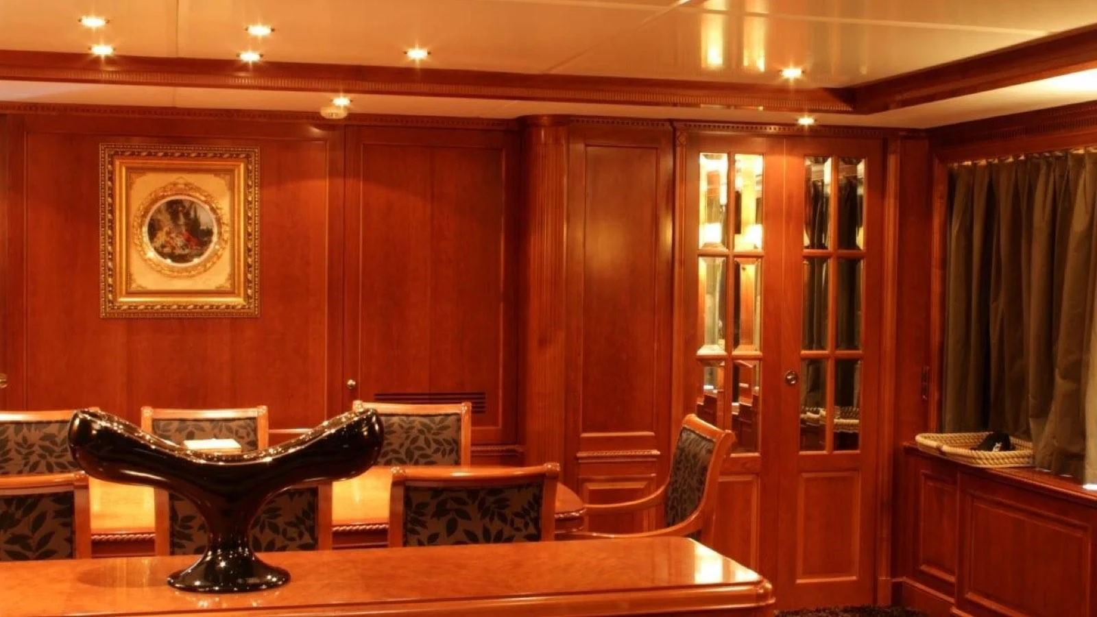 a room with a table and chairs aboard BENETTI TRADITION 100 Yacht for Sale