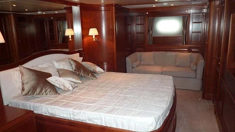 a bed with a white bed aboard BENETTI TRADITION 100 Yacht for Sale