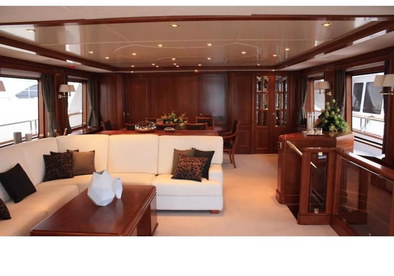 a living room with a couch and a coffee table aboard BENETTI TRADITION 100 Yacht for Sale