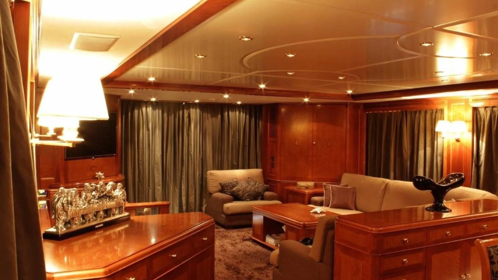 a living room with a couch and a coffee table aboard BENETTI TRADITION 100 Yacht for Sale