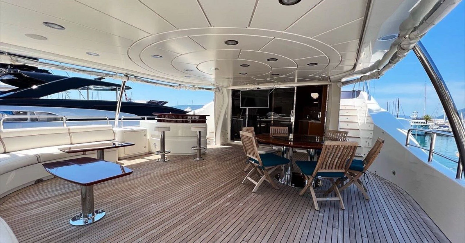 a room with tables and chairs aboard BENETTI TRADITION 100 Yacht for Sale