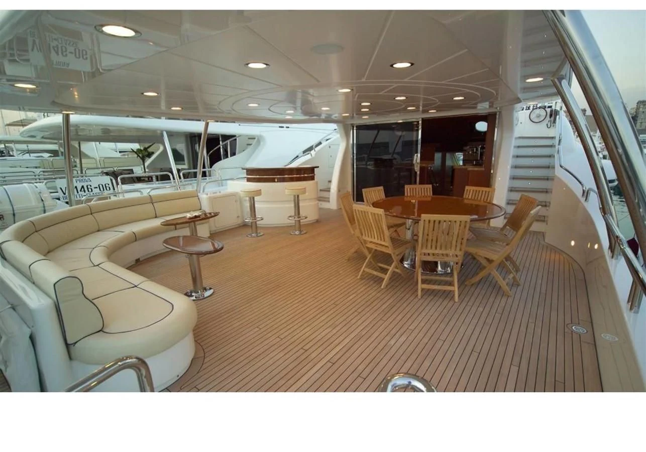 a room with tables and chairs aboard BENETTI TRADITION 100 Yacht for Sale