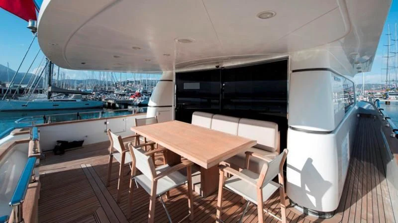 a table and chairs on a deck aboard MARIS STELLA Yacht for Sale