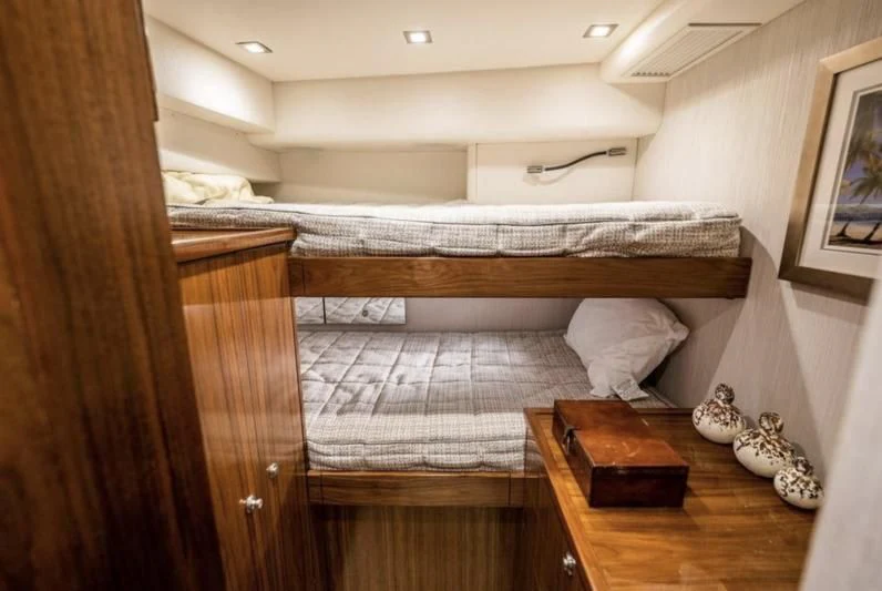 a bed with a wooden frame aboard 17 Yacht for Sale