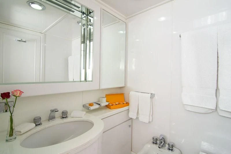 a bathroom with a sink and a mirror aboard O'NATALINA Yacht for Sale