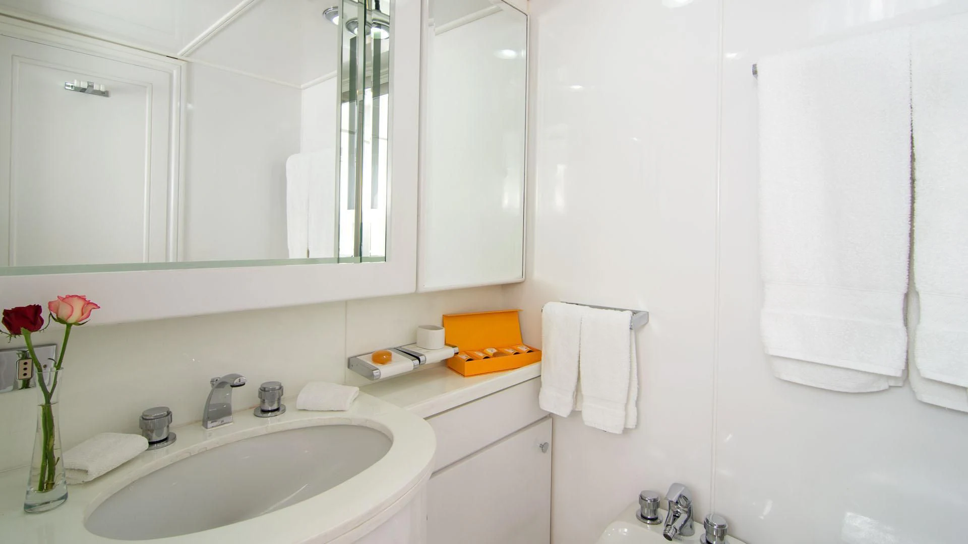 a bathroom with a sink and towels aboard O'NATALINA Yacht for Sale