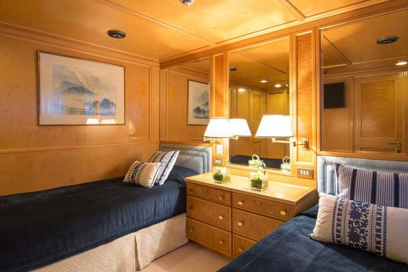 a bedroom with a bed and a desk aboard O'NATALINA Yacht for Sale