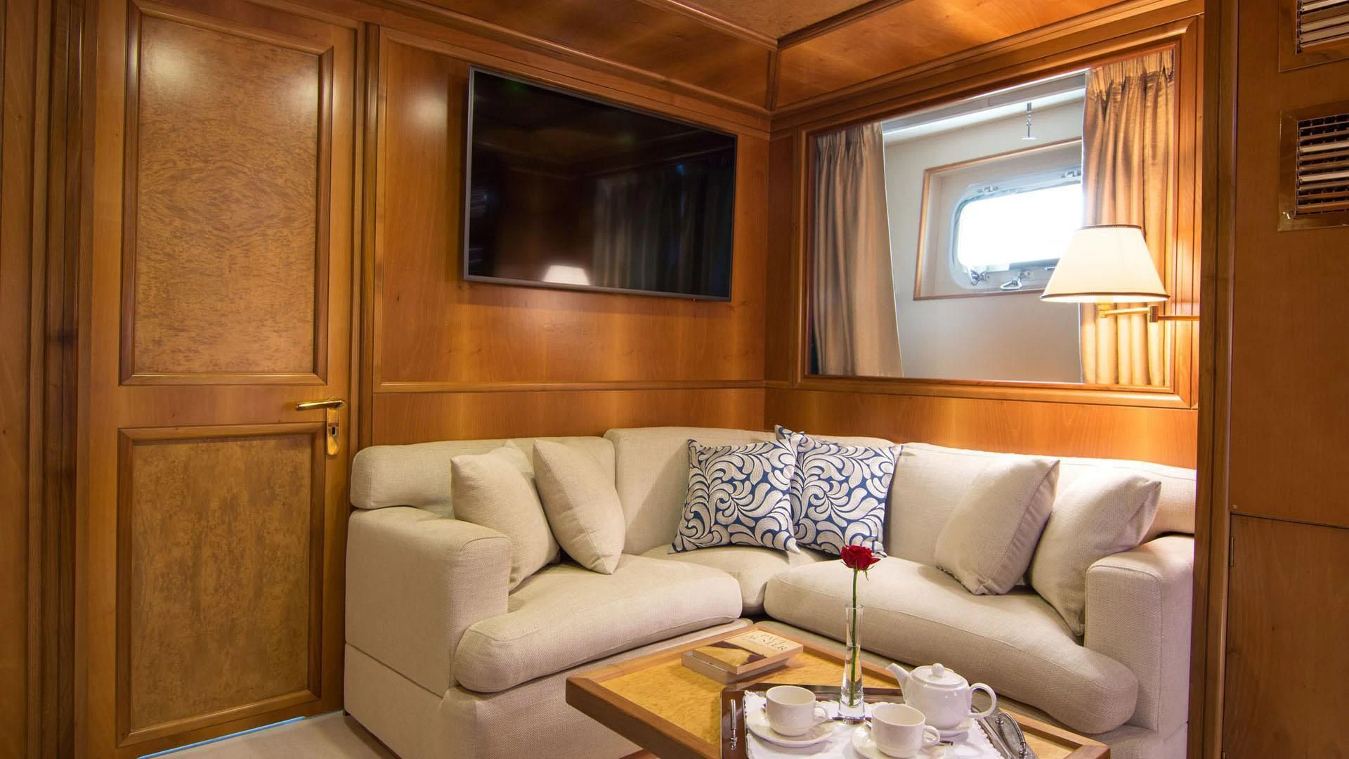 a living room with a couch and a table aboard O'NATALINA Yacht for Sale