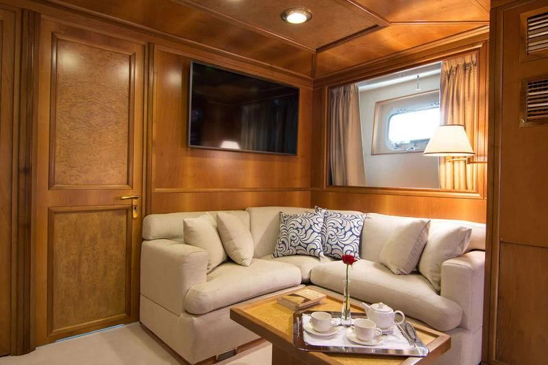 a living room with a couch and a table aboard O'NATALINA Yacht for Sale