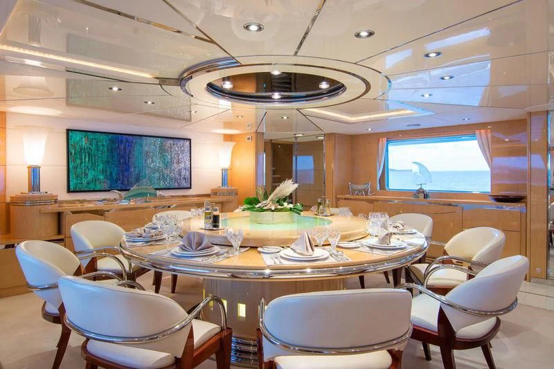 a large room with tables and chairs aboard O'NATALINA Yacht for Sale