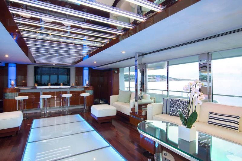 a room with a table chairs and a couch aboard O'NATALINA Yacht for Sale