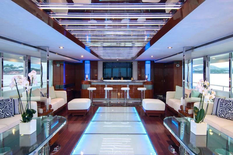 a room with tables and chairs aboard O'NATALINA Yacht for Sale