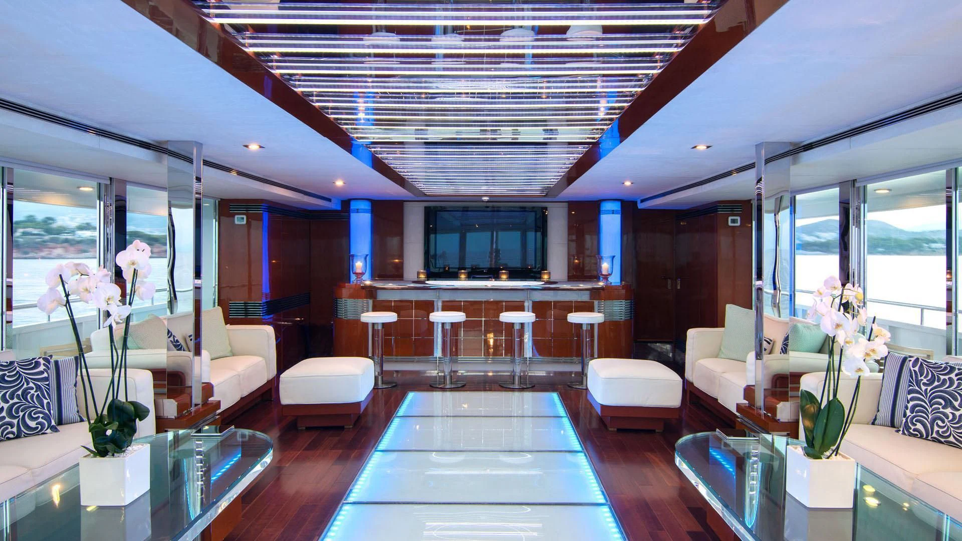 a room with a table chairs and a couch aboard O'NATALINA Yacht for Sale