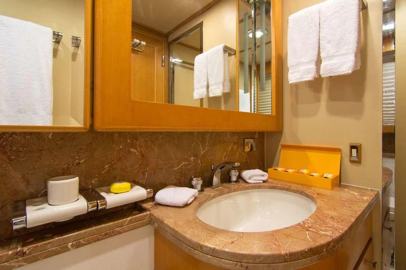 a bathroom with a sink and towels aboard O'NATALINA Yacht for Sale