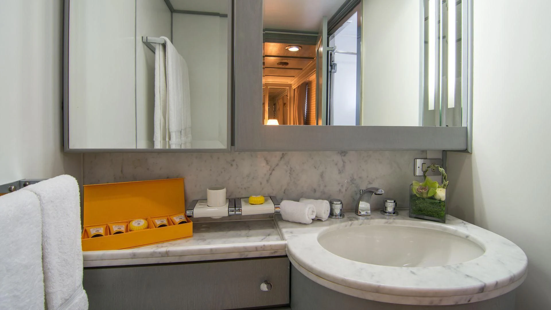a bathroom with a sink and a mirror aboard O'NATALINA Yacht for Sale