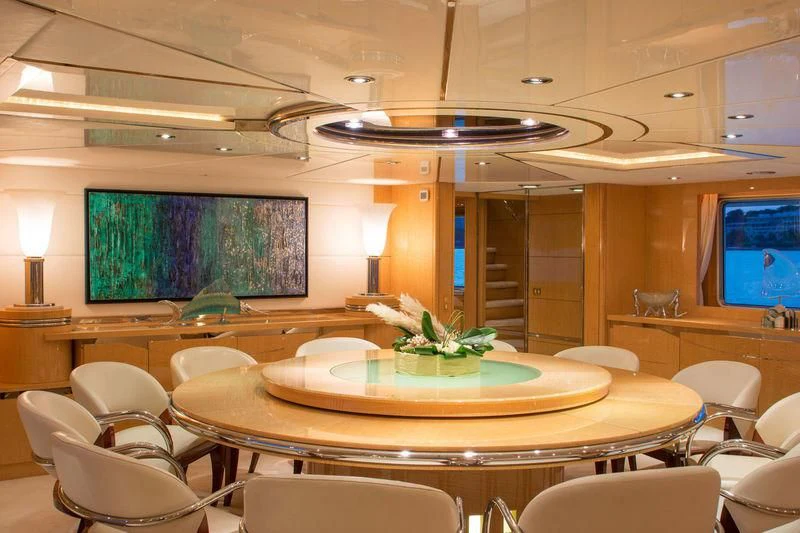 a room with tables and chairs aboard O'NATALINA Yacht for Sale